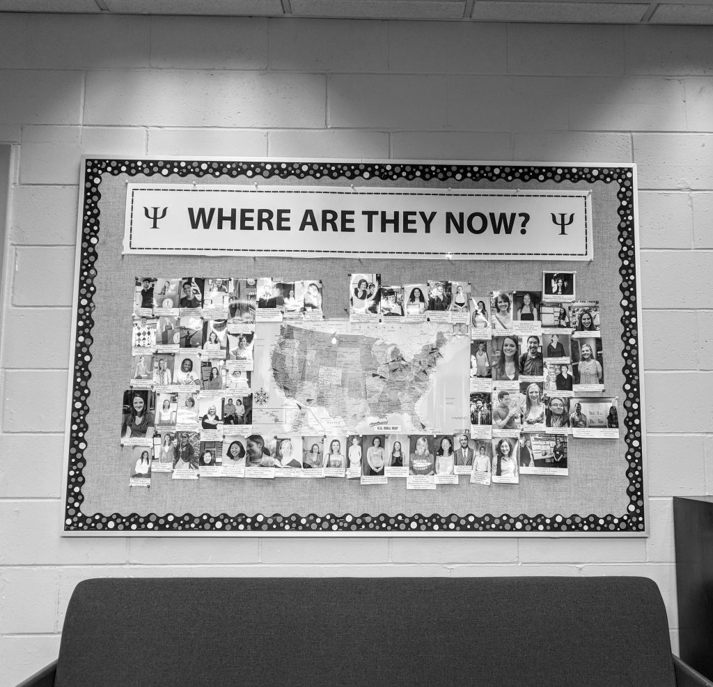 Alumni photos and map on bulletin board